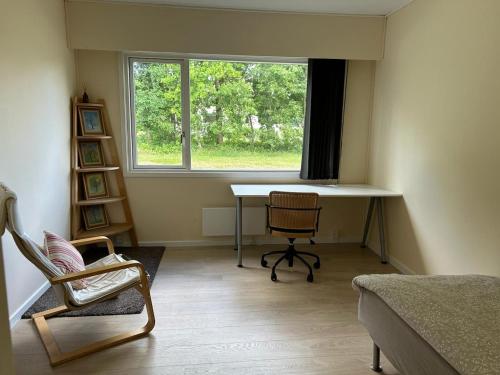 a room with a desk and a chair and a window at Tvind B&B in Ulfborg
