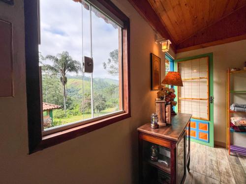 a room with a window with a view of a mountain at Fazenda Rio Do Peixe SFX in São José dos Campos