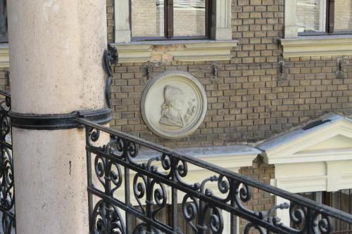 a statue of a child on the side of a building at Omega Guesthouse Budapest in Budapest