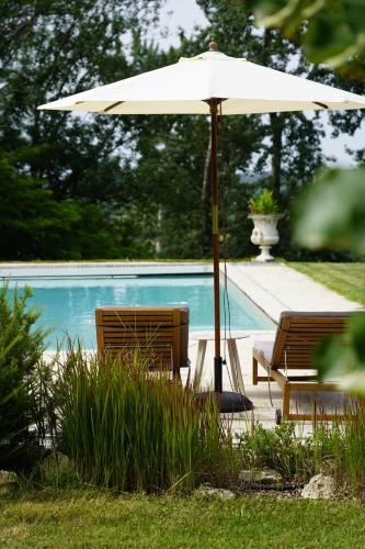 - un parasol blanc, 2 chaises et une piscine dans l'établissement Chateau de Pomiro chambres d'hôtes et gîte, à Montréal
