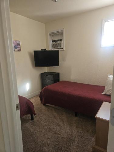 a hotel room with two beds and a flat screen tv at Camaray Motel in Oroville