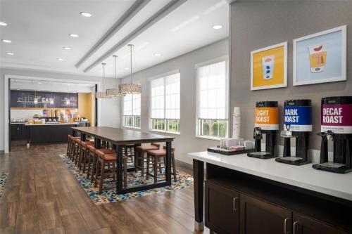 a kitchen and dining room with a table and chairs at Hampton Inn-Pawtucket, RI in Pawtucket