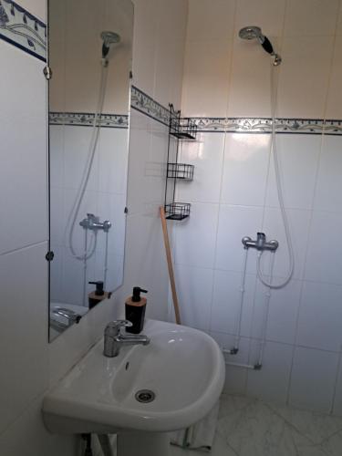 a white bathroom with a sink and a shower at NN Residence Tabarka in Tabarka