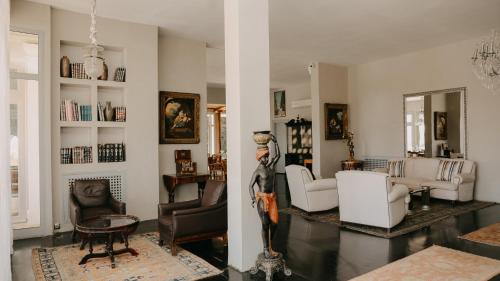 a living room with white furniture and a table at Villa Soraya Lodge & Spa in Rabat