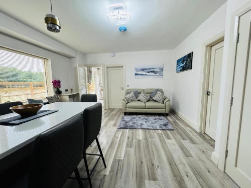 a living room with a table and a couch at Two bedroom cottage near Maynooth University in Maynooth