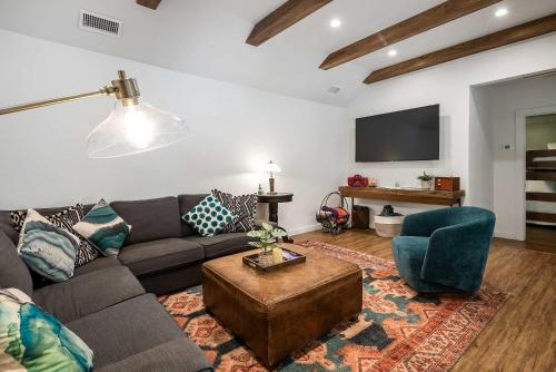 a living room with a couch and a tv at Updated Downtown home next to NAU in Flagstaff