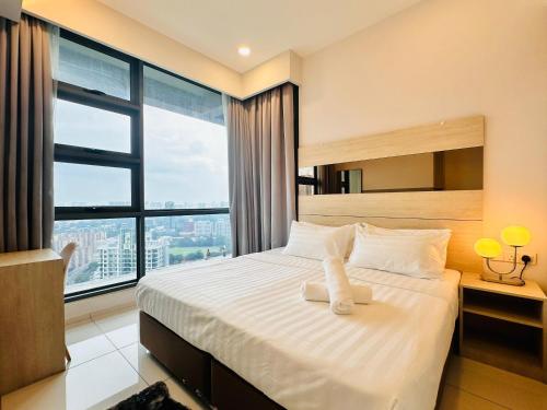 a bedroom with a white bed with a large window at The Robertson Family Suite Bukit Bintang KL in Kuala Lumpur
