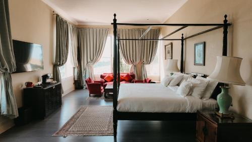 a bedroom with a large bed and a living room at Villa Soraya Lodge & Spa in Rabat