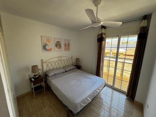 a bedroom with a bed and a ceiling fan at Brisa y Mar Aguadulce II in Aguadulce
