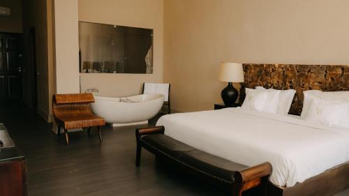 a bedroom with a bed and a bathtub and a bed and a bathtub at Villa Soraya Lodge & Spa in Rabat