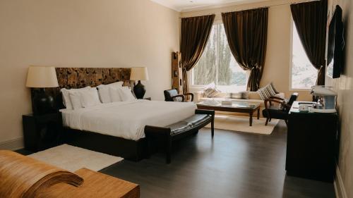 a hotel room with a bed and a living room at Villa Soraya Lodge & Spa in Rabat