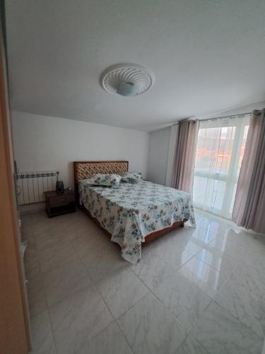 a bedroom with a bed with a comforter on it at NN Residence Tabarka in Tabarka