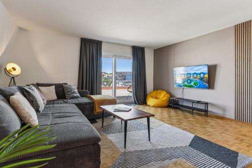 a living room with a couch and a table at maremar Apartments - Schlafen in der Altstadt - Luxus Boxspring - Küche in Minden