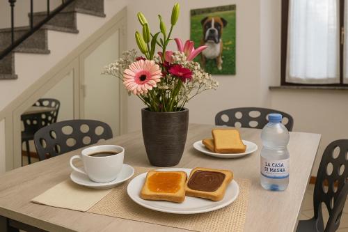 a table with two slices of bread and a cup of coffee at La Casa di Masha in Paderno Dugnano
