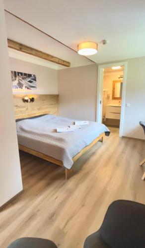 a bedroom with a large bed in a room at Hotel Landhaus Lungau in Sankt Michael im Lungau