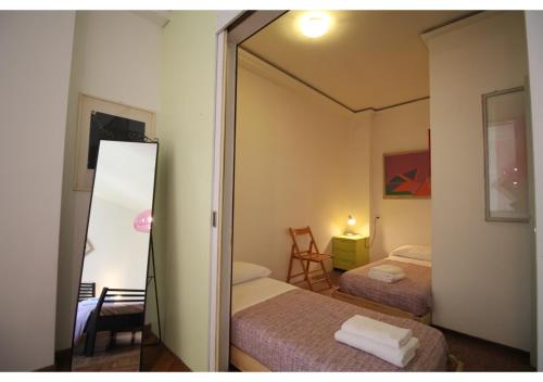 a small bedroom with two beds and a mirror at CANAL-VIEW, Apartment in Venice in Venice