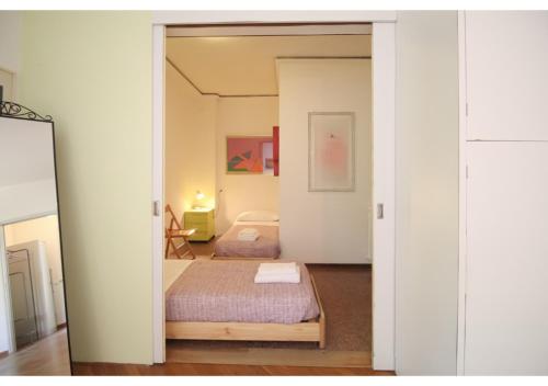 a small bedroom with a bed and a mirror at CANAL-VIEW, Apartment in Venice in Venice
