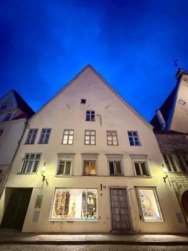 a white building at night with lights at Luxury Suites in the Heart of Medieval Tallinn Old Town in Tallinn