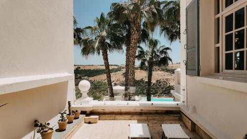 a balcony with palm trees and a view of the ocean at Villa Soraya Lodge & Spa in Rabat
