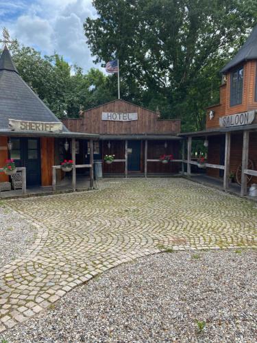 a cobblestone parking lot in front of a hotel at Klondike City in Vojens