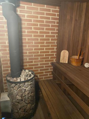 a fireplace in a room with a bench and a brick wall at Klondike City in Vojens