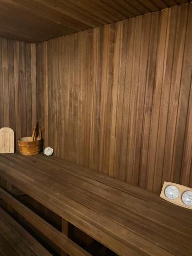 a wooden shelf in a sauna with clocks on it at Klondike City in Vojens