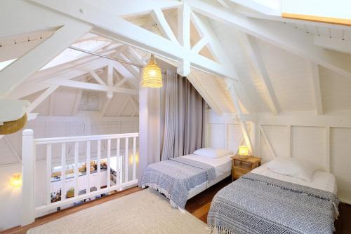 a bedroom with two beds in a attic at Charming villa with swimming pool for 6-8 in Saint-François