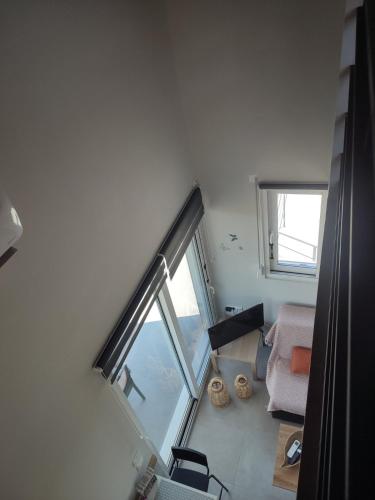 a room with a large window and a couch at Lemon Loft in Preveza