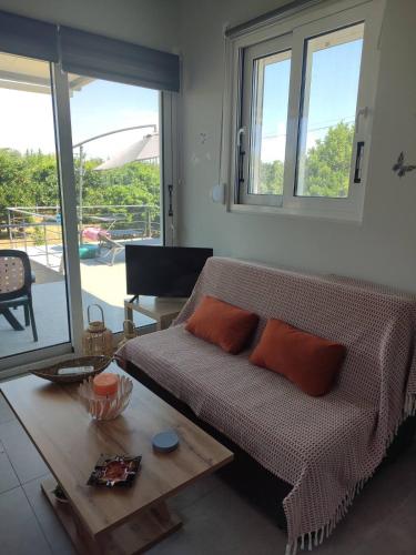 a living room with a couch and a table at Lemon Loft in Preveza