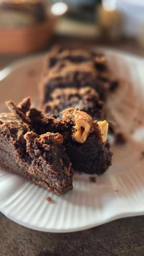 a white plate with three pieces of chocolate cake at Pousada Viva Praia in Paracuru