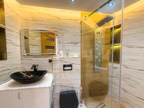 a bathroom with a glass shower and a sink at Essalmi Luxury Apartment in Marrakech in Marrakech