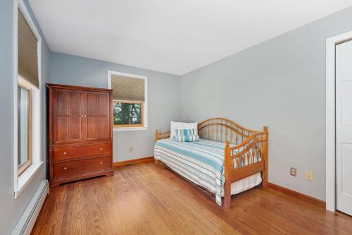 a bedroom with a bed and a dresser and a window at 4 Harvest Hollow Harwich Port Cape Cod- - We Shall Sea in Harwich Port