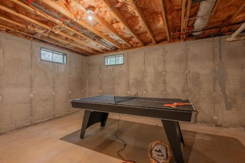 a ping pong table in the middle of a room at 4 Harvest Hollow Harwich Port Cape Cod- - We Shall Sea in Harwich Port