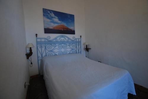 a bedroom with a white bed in a room at Vulcanoconsult Appartamenti Spiaggia in Lipari