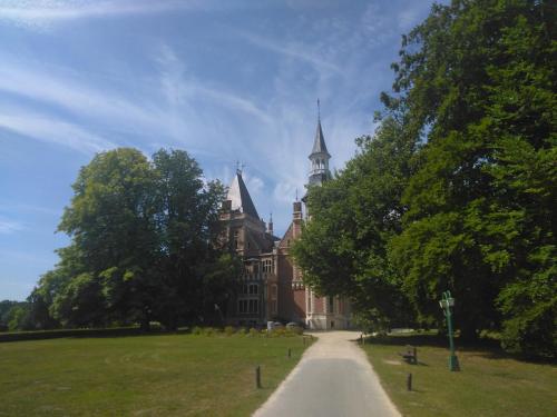 an old building with a path in front of it at Green garden in Torhout