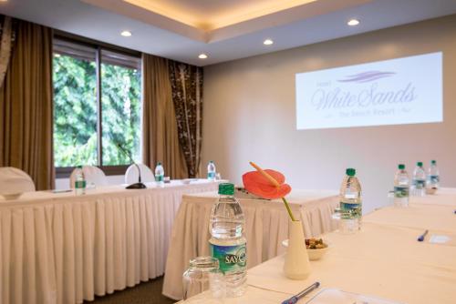 a meeting room with two tables with bottles of water at White Sands Hotel in Dar es Salaam