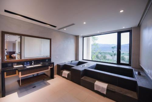 a bathroom with two sinks and a large window at Chii Lih Resort in Luye