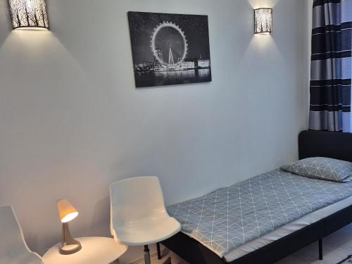a small room with a bed and a chair at Noclegi "LAS WYPAS" Trzcianka in Trzcianka