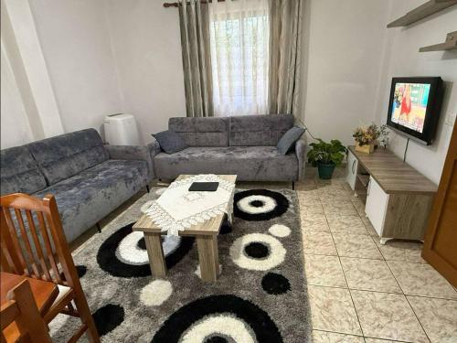 a living room with a couch and a table at Guest House Tirana in Tirane