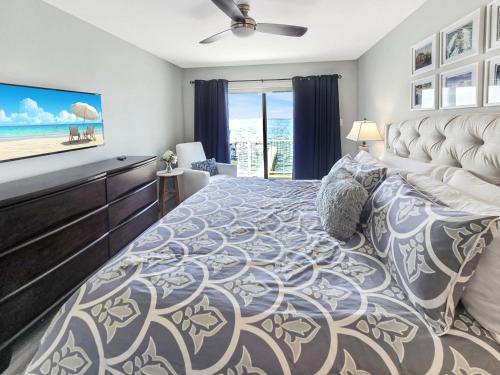 a bedroom with a large bed with a view of the ocean at AWave From It All lakefront on Big Spirit Lake in Orleans