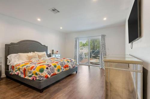 a bedroom with a bed with a colorful comforter at The Hatteras Haven With Pool in Los Angeles