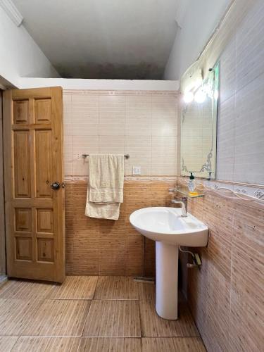 a bathroom with a sink and a mirror at Modern 3-Bed Retreat E11 PEACEFUL in Islamabad