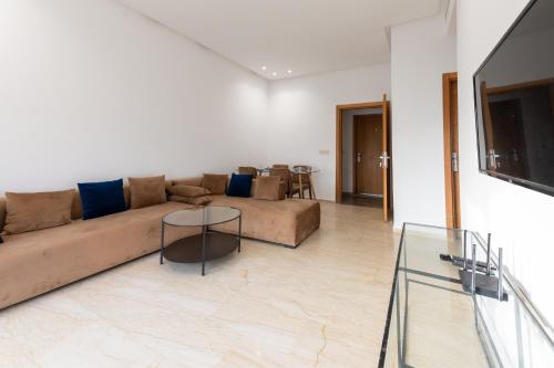 a living room with a couch and a table at Garden Bay Appart'Hôtel in Casablanca