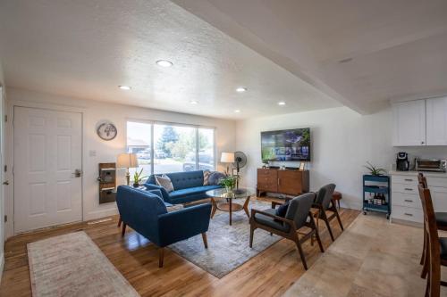 a living room with a blue couch and chairs at LilyPad Pet friendly Retreat in Sandy