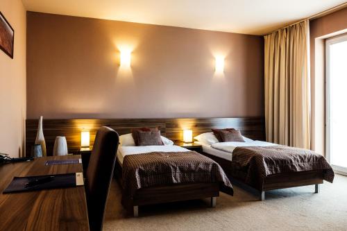 Ένα ή περισσότερα κρεβάτια σε δωμάτιο στο Hotel Comfort with free Wellness and Fitness Centrum