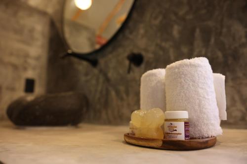 a pile of toilet paper and a bottle of medicine at Ecoaldea Tanaj Hotel Boutique in Conhuas