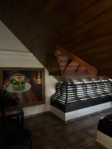 a room with a painting of a frog on the wall at Thampurans lakefront properties in Changanācheri