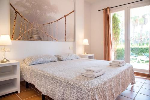 a bedroom with a bed with two towels on it at Heavenly Homes Mojcar 93 in Mojácar