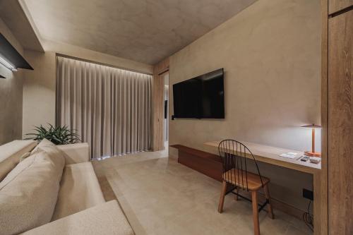 a living room with a couch and a desk at Kuuna Luxury Stays by Wynwood House in Medellín