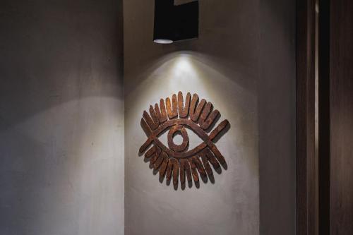 a wooden shield on the side of a wall at Kuuna Luxury Stays by Wynwood House in Medellín